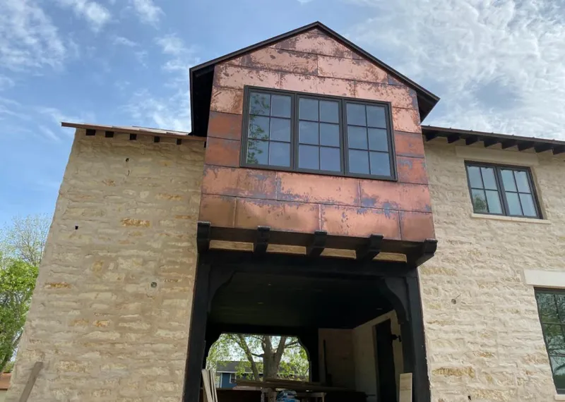 Copper metal panel facade on a stone building for Metal Roof Coating in Petal