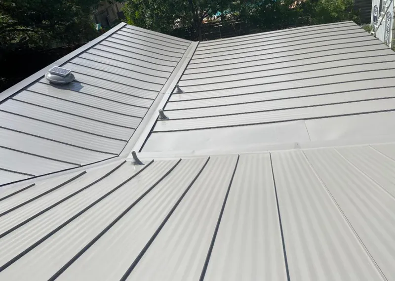 Solar attic fan installed on a metal roof for Roof Ventilation in Petal